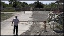 A man stands near the closed boundary barrier between the Georgian village of Ergneti and Tskhinvali, regional capital of Georgia's breakaway province of South Ossetia, 5 August 2009